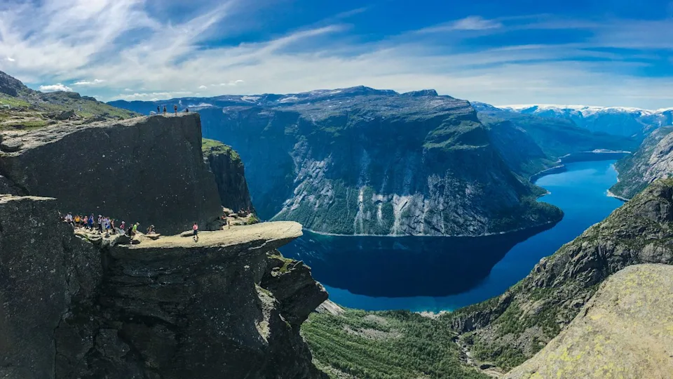 July 26, 2019. Norway tourist route on the trolltunga. People tourists go hiking in the mountains of Norway in fine sunny weather to thetrolltunga. Hiking backpack theme.