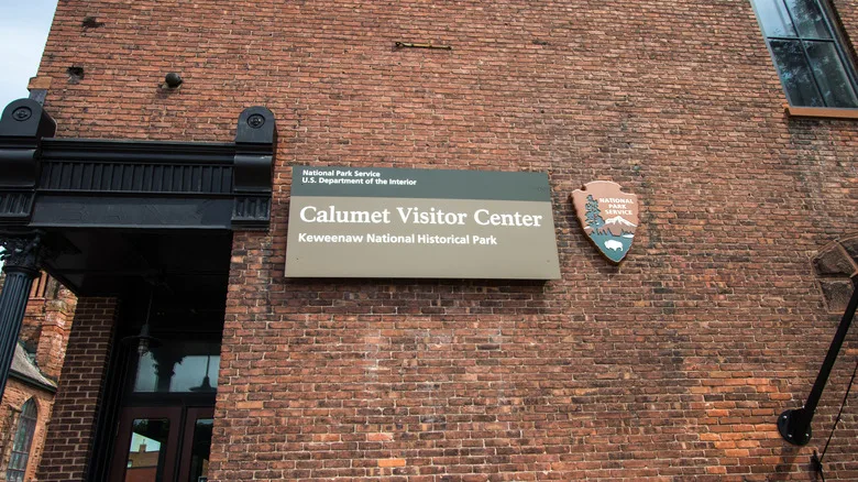 Side of brick building with Calumet Visitor Center National Park Service sign