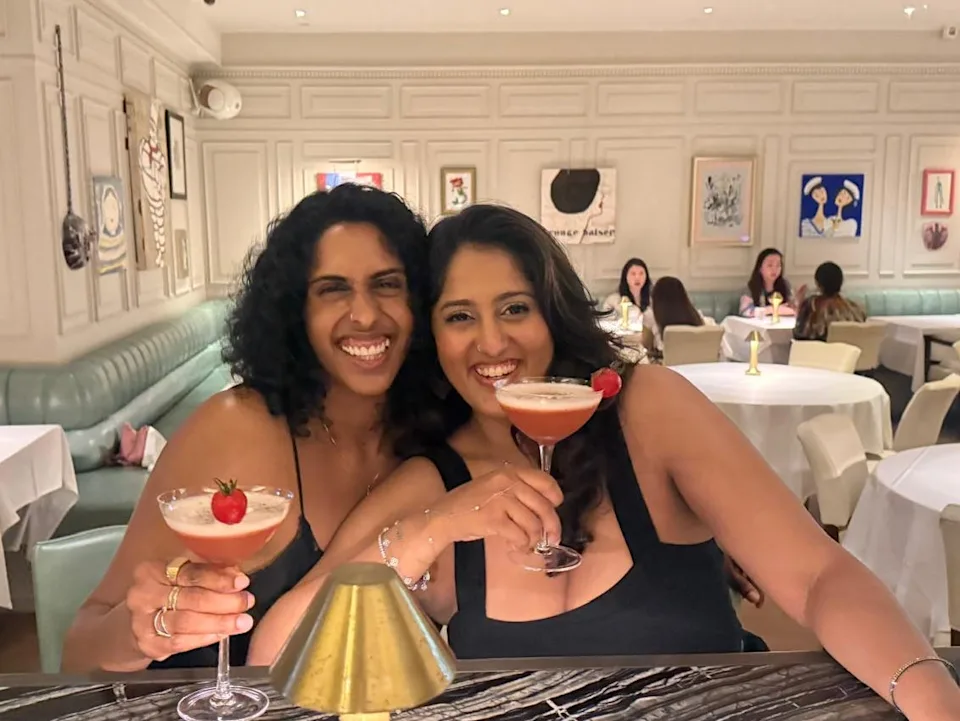 Two women sipping cocktails in Hong Kong.