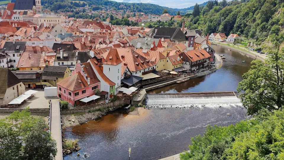 Scenic view of Český Krumlov, a historic town in the Czech Republic. The Old Town with its red roofs is surrounded by the Vltava River. A popular tourist destination.