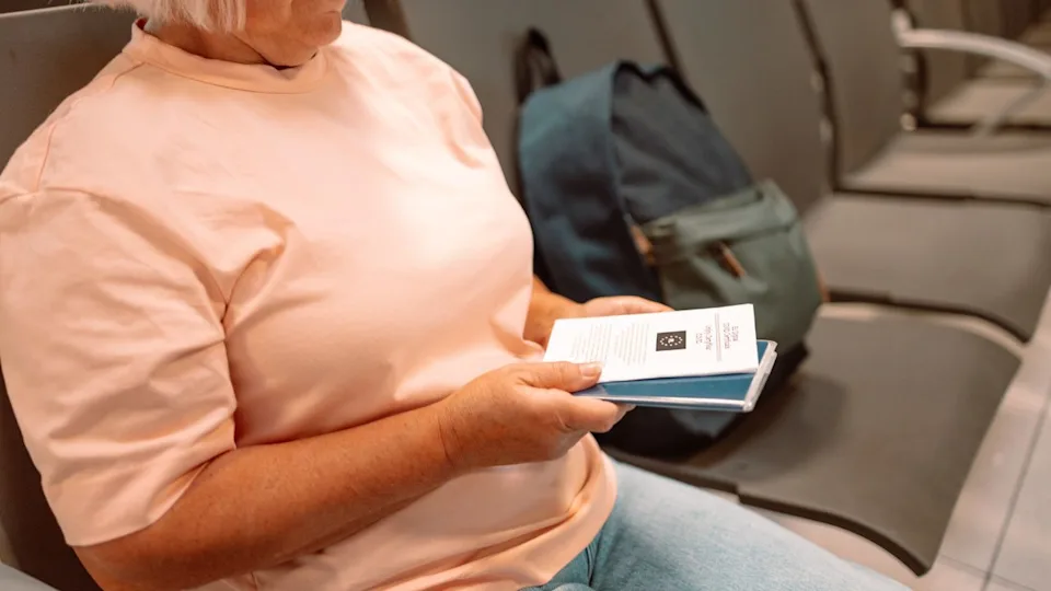 Qr code, check in and man with a phone for a ticket, airplane booking and information at airport. Travel, website and hand of a businessman reading a barcode on a mobile for a work trip or vacation