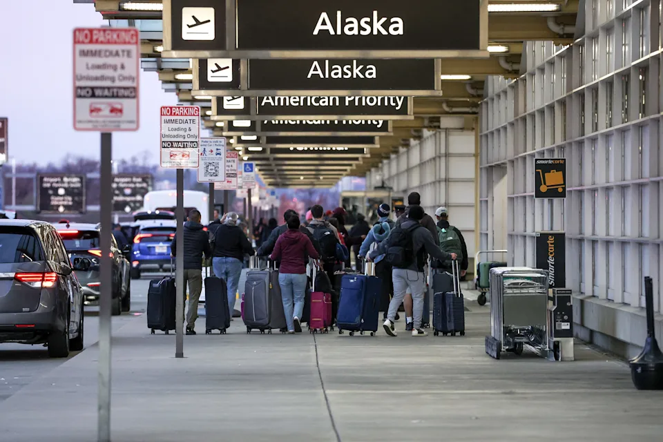Travelers arrive at the Ronald Reagan Washington National Airport on November 25, 2025 in Arlington, Virginia.