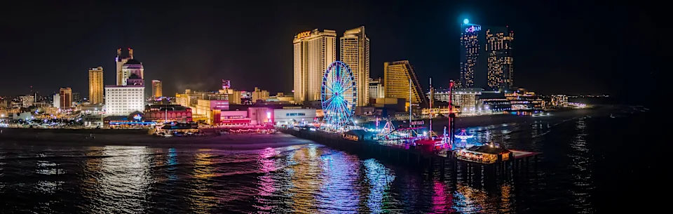 Night view of the Boardwalk and Downtown Atlantic City's waterfront in New Jersey.