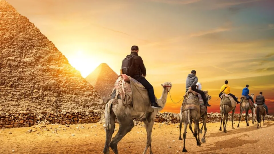 Camel Caravan and the Pyramids of Giza in Egypt