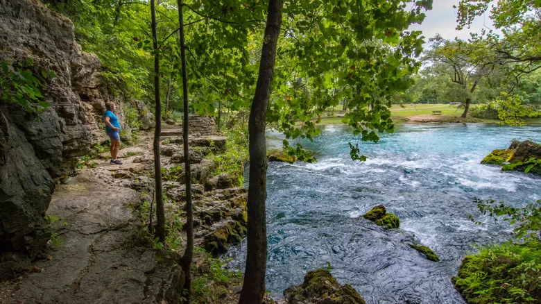 A hiker on the stone trail around Big Spring in Missouri's Ozark National Scenic Riverways