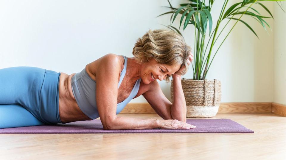  A senior woman on a workout mat. 