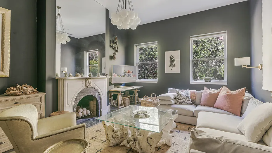 The living room features a grand fireplace and a chandelier.