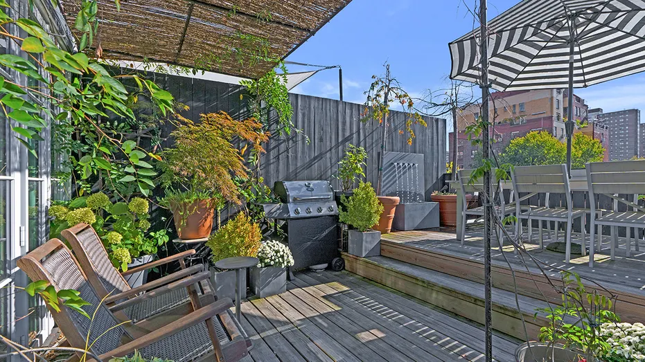One of the outdoor terraces features an outdoor kitchen and dining area.