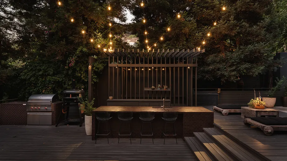 The backyard also features an outdoor bar and kitchen.