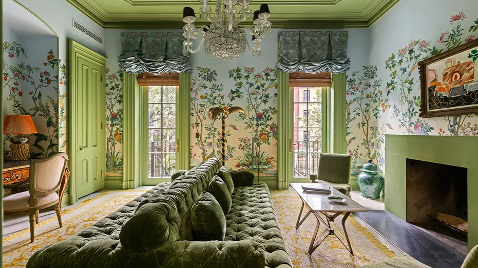 The living room includes bold wallpaper and a statement chandelier