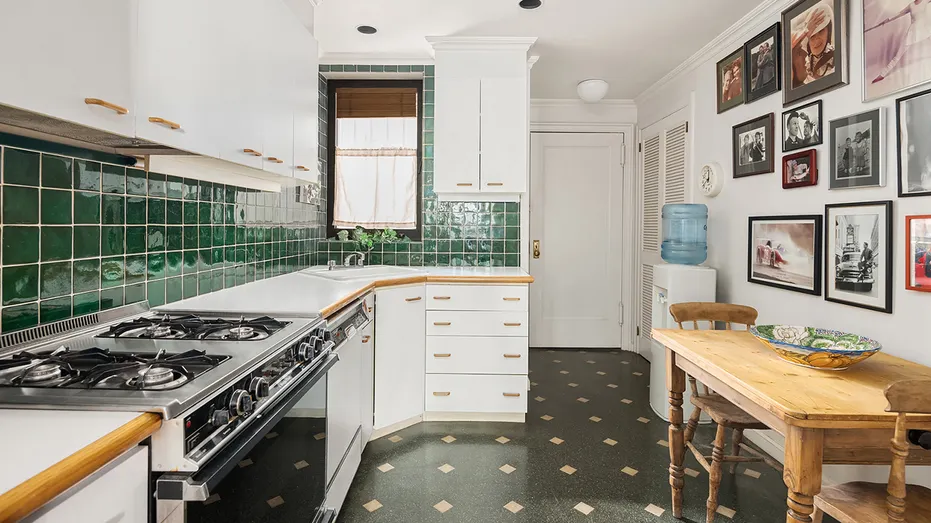 The kitchen features green tiled backsplash and a dining area.