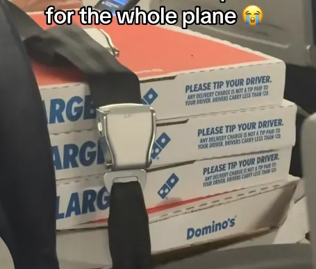 Dominos pizza boxes strapped into a seatbelt