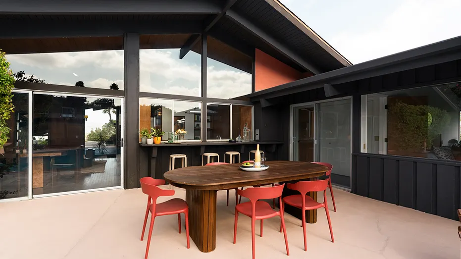 The backyard features an outdoor bar and dining area.