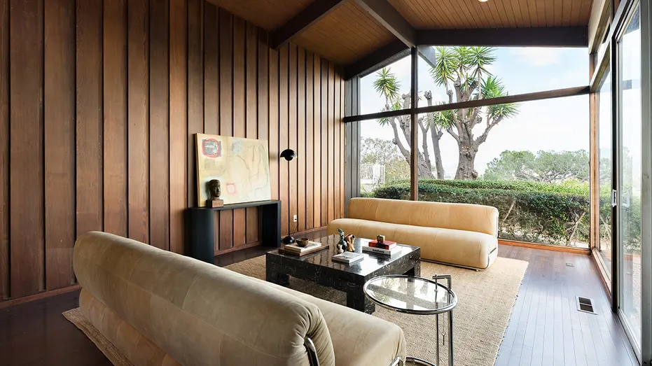 A sitting room with floor-to-ceiling windows.