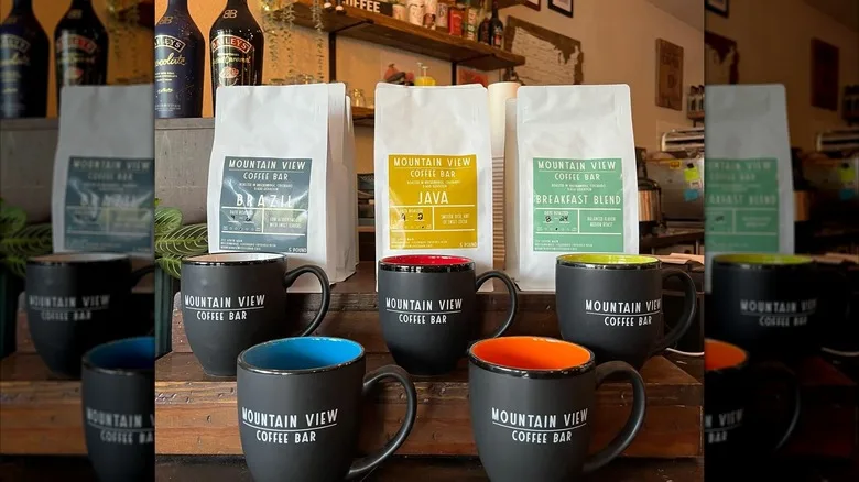 Inside store with branded coffee mugs and bagged coffee beans