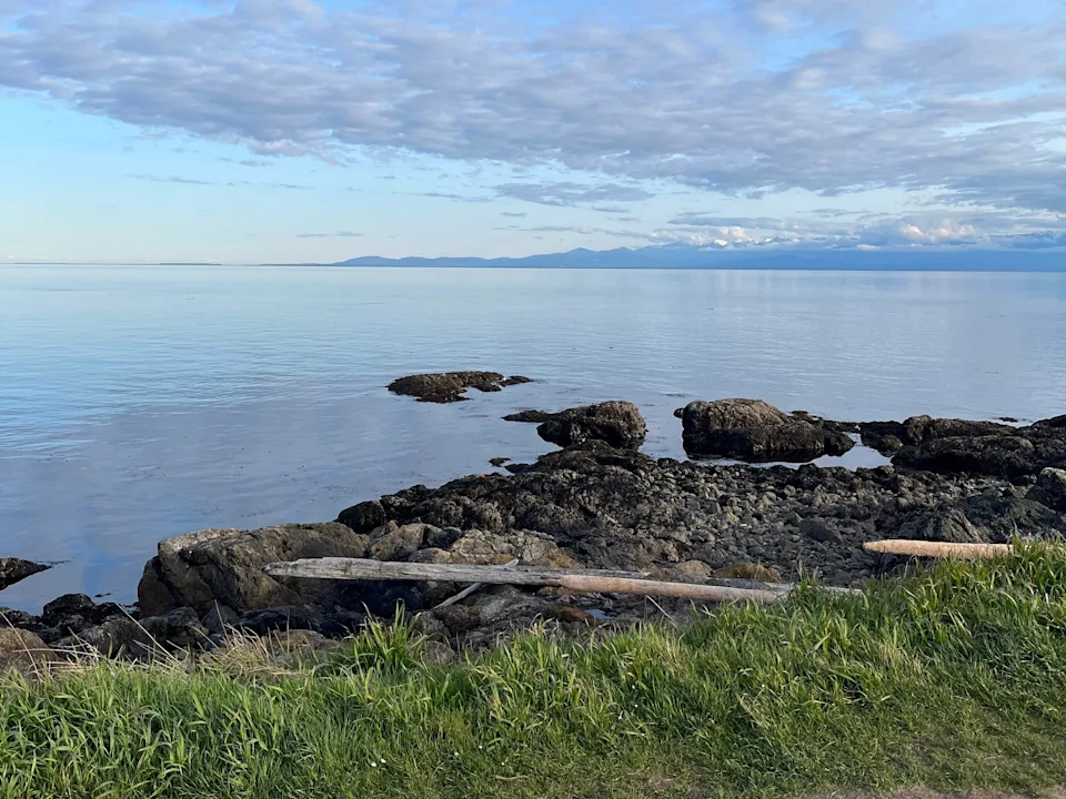 view of the ocean and mountains on the coast of victoria canada