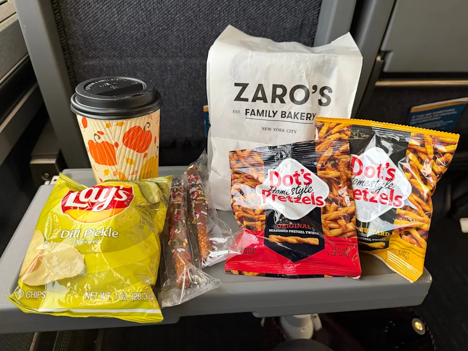 Snacks laid out on an Amtrak seat's tray table.