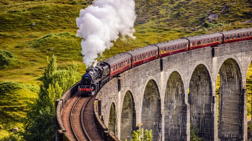 GLENFINNAN, SCOTLAND, UNITED KINGDOM - SEPTEMBER 9, 2015 Glenfinnan Railway Viaduct in Scotland with the Jacobite steam train passing over