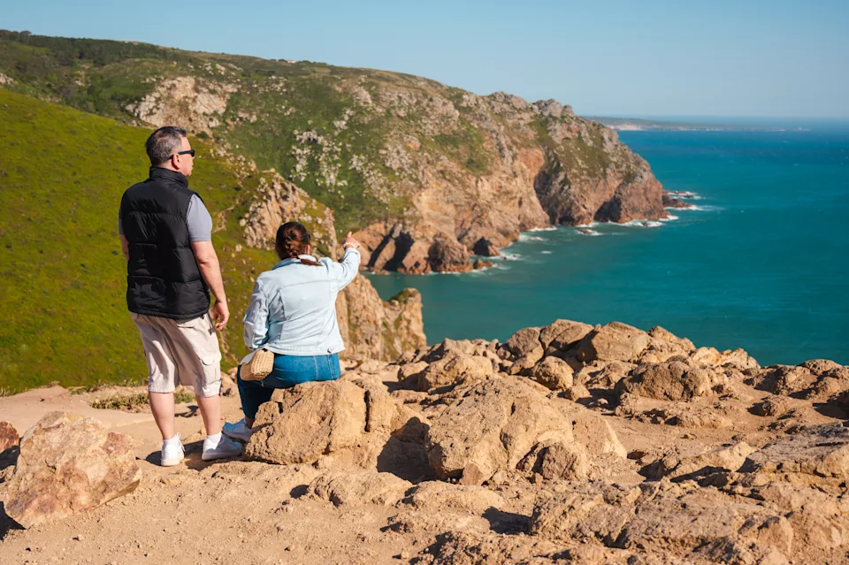 Retired American couple enjoying ocean views along Portugal’s coastline while considering the D7 visa for long-term residency