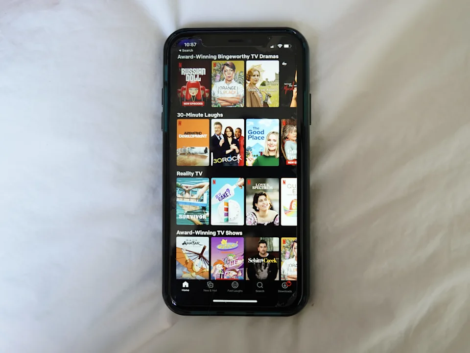 Netflix selections on a black iPhone with a white background