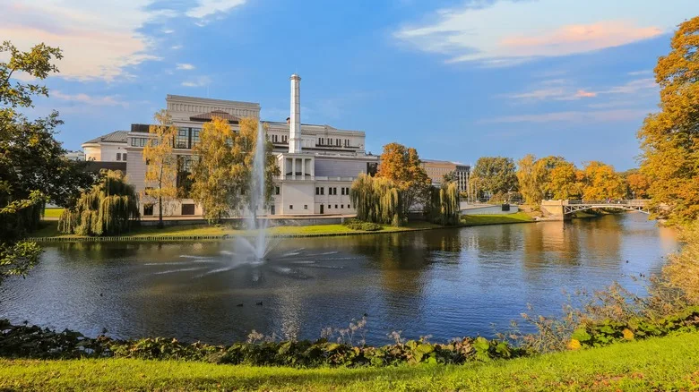 Autumn in Riga, view of the City Channel in the autumn colors and National Opera building reflected in the water