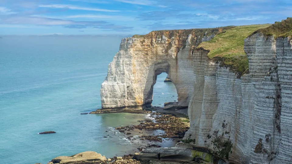 27.06.2023 Étretat, Seine-Maritime Normandy, France.. Étretat is best known for its chalk cliffs, including three natural arches and a pointed formation called L'Aiguille or the Needles