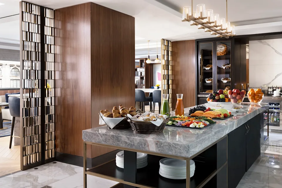 The Langham New York Club Lounge with soft seating, dining tables and all-day food service.