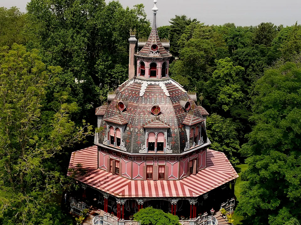 A mansion shaped like an octogan overlooking a river.