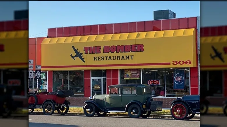 Exterior of The Bomber Restaurant with vintage cars out front