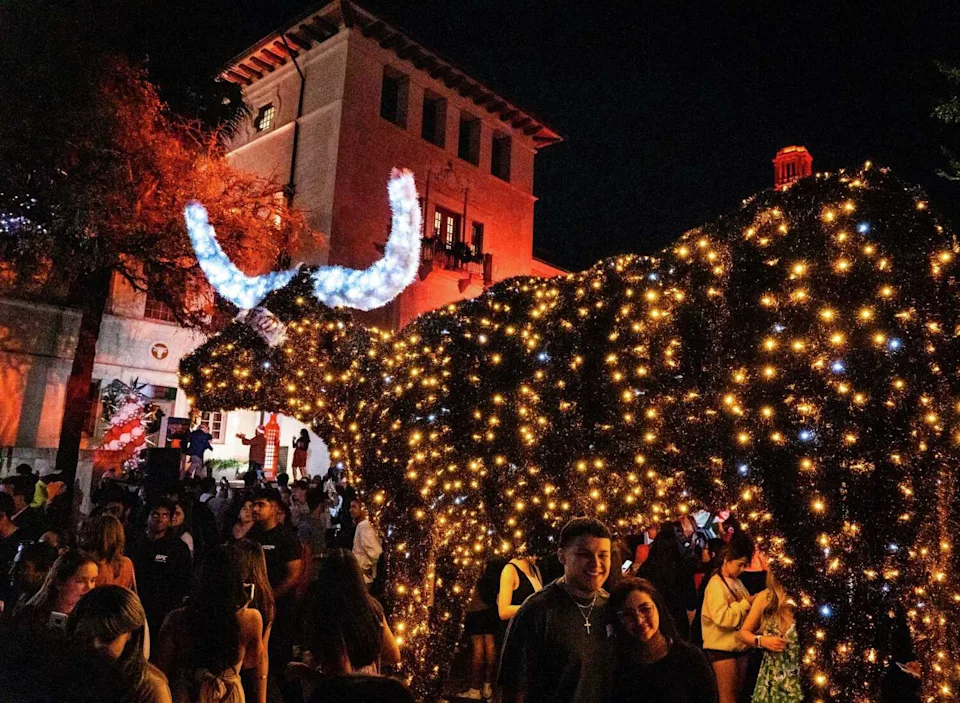 Texas students mill around the holiday light Bevo at the lighting of Longhorn Lights, the University of Texas' annual holiday light display along Guadalupe Street, Nov. 19, 2024. (Sara Diggins/American-Statesman)