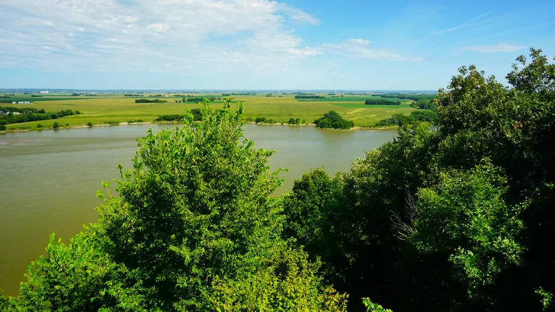 River and trees shown in Ponca State Park during the day.