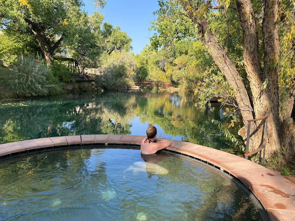 A woman in the water at an outdoor spa.
