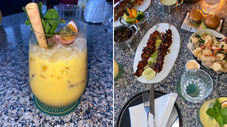 I enjoyed a refreshing passion-fruit drink and a table filled with appetizers and skewers at Atmosphere Restaurant in Dubai.