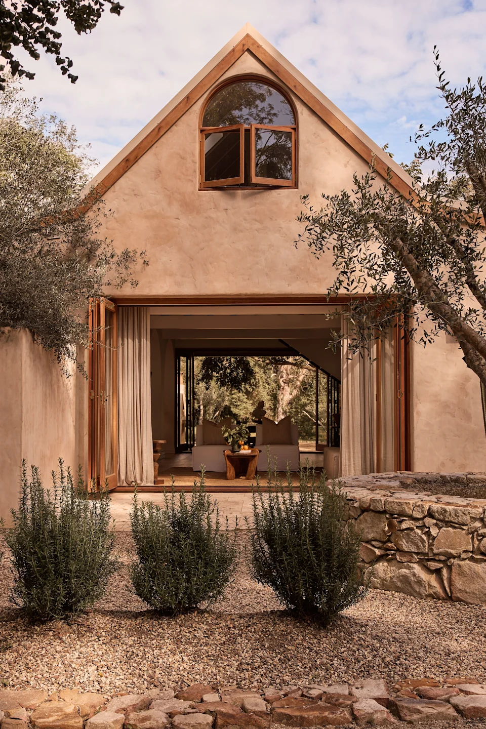 The handcrafted stone walls and elegant arches at Casa Renoir in Noosa make a larger statement about environmental stewardship.