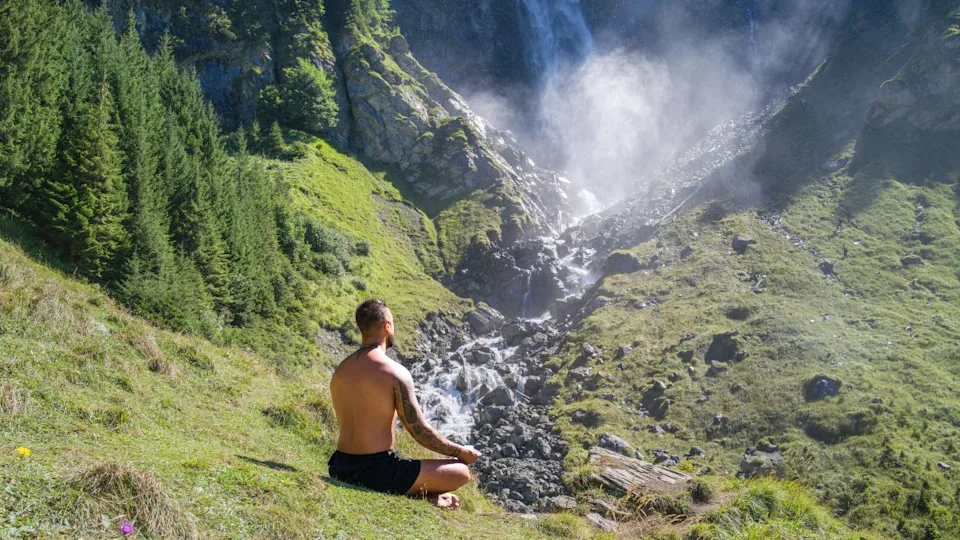 Meditation. Harmony and peace in nature. Calm athlete man meditating in environment. Mindfulness. Relaxed man in nature. Freedom and happiness. Man practicing yoga outdoors.