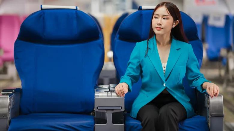 beautiful woman sitting on airplane blue seat