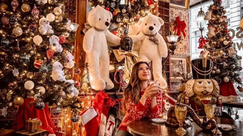 Woman enjoying a drink at Oscar Wilde during Christmas event.