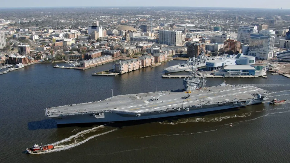 USS Harry S. Truman in the Elizabeth River with downtown Norfolk in the background, near the Norfolk Naval Shipyard