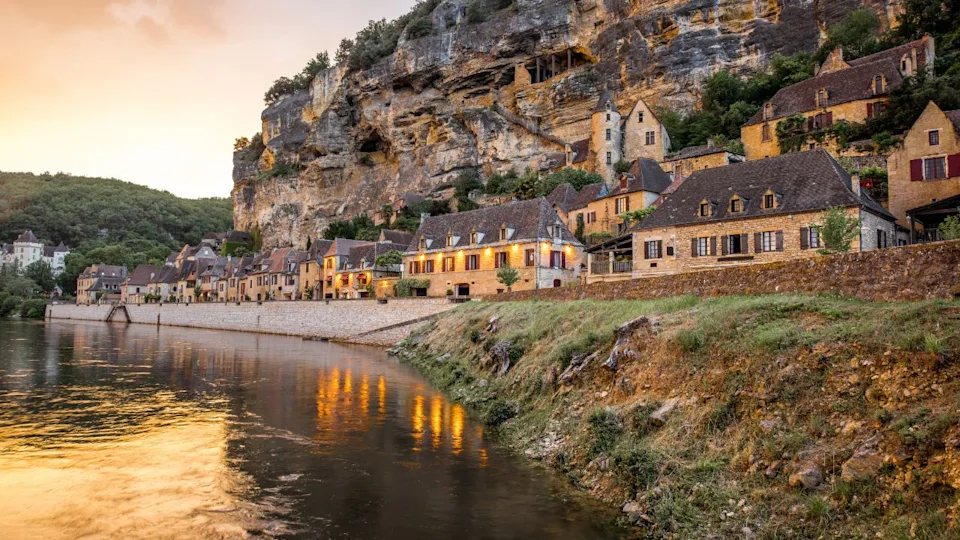 Beautiful sunset view on Dordogne river and famous La Roque Gageac village during the rainy weather in France
