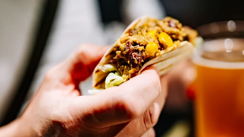 Holding a Mexican taco