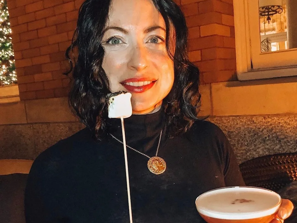 simone holding up a roasted marshmallow and a cocktail at the fairmount empress hotel