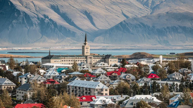 Cityscape of downtown Reykjavik in Iceland, featuring colourful houses, Tækniskólinn college and mountain Esjan in the background