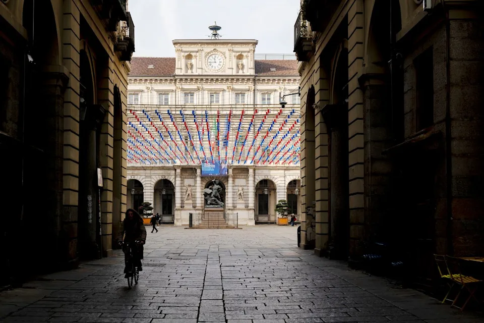 Laura La Monaca/Travel + Leisure A cyclist on the streets of Turin.