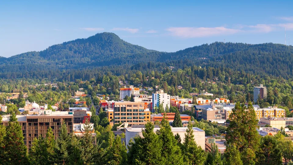 Eugene, Oregon, USA downtown cityscape and mountains in the afternoon.
