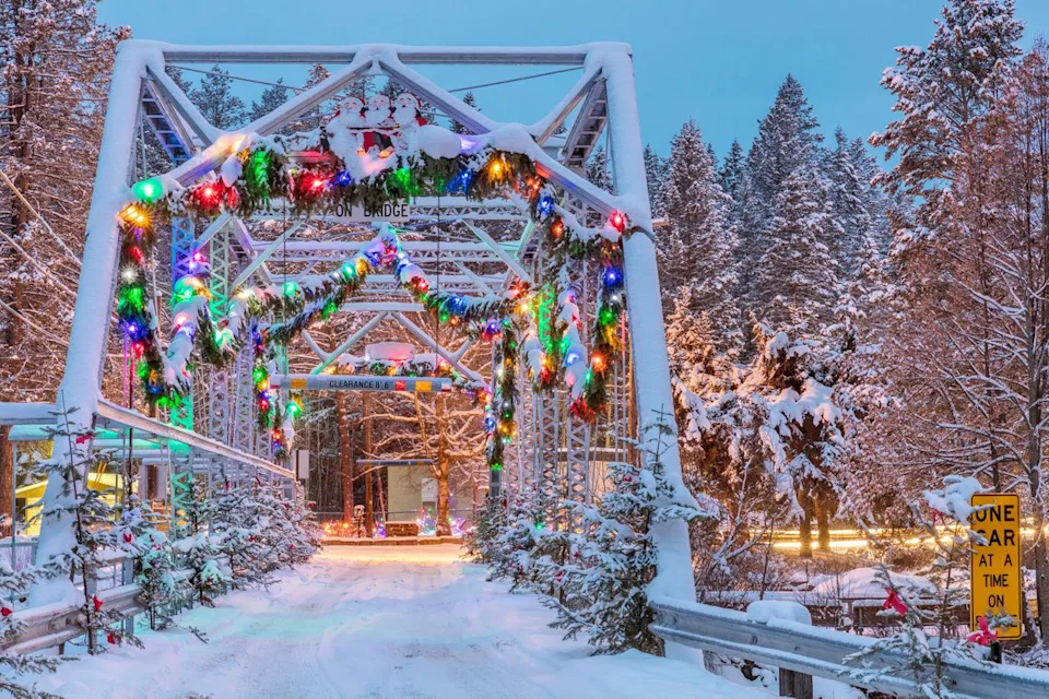 Danita Delimont/Alamy Christmas decorations cover a bridge over the Swan River in Bigfork, Montana.