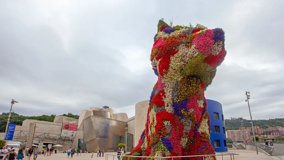 Bilbao, Spain - July 15, 2024: The floral sculpture 'Puppy' - Standing in front of Bilbao s Guggenheim Museum at 43 feet tall, the flower-covered topiary is a symbol of Spain s fifth-largest city.