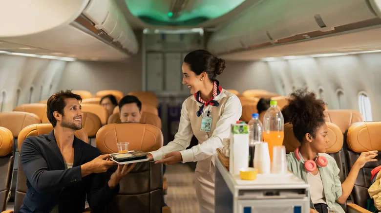 air stewards taking care of passengers while on flight