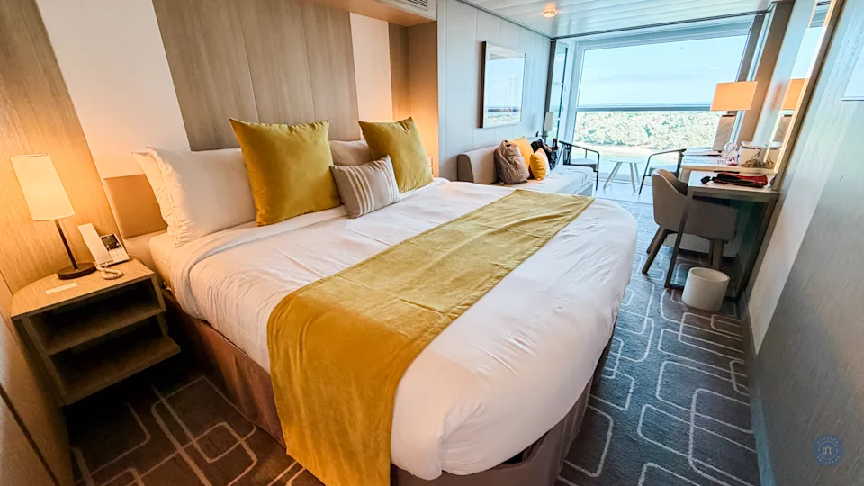 room with king bed and couch with infinite verandah on celebrity xcel