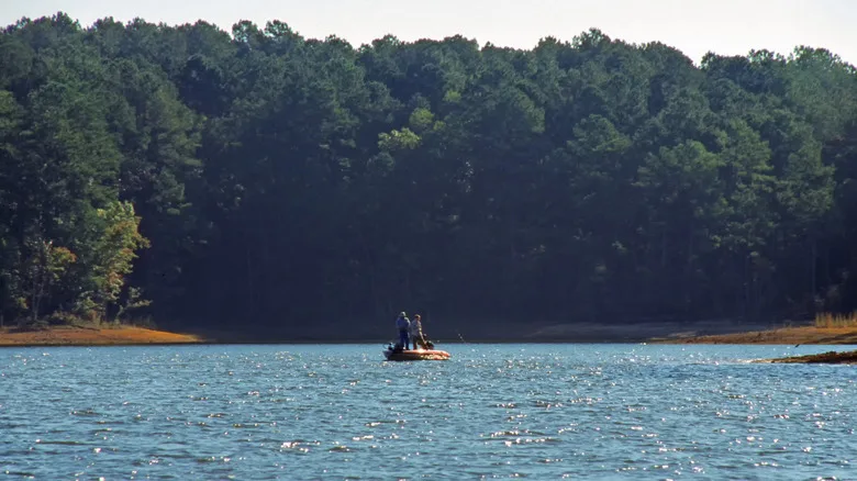 Fishermen stand on their boat in the middle of Lake Thurmond
