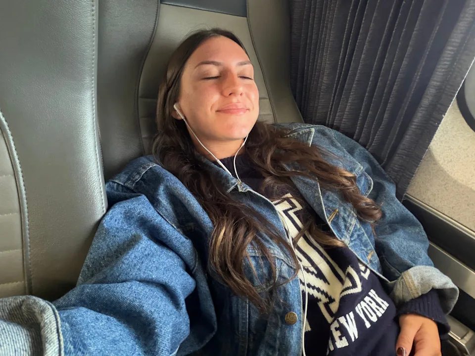 Amanda reclining on an Amtrak seat.